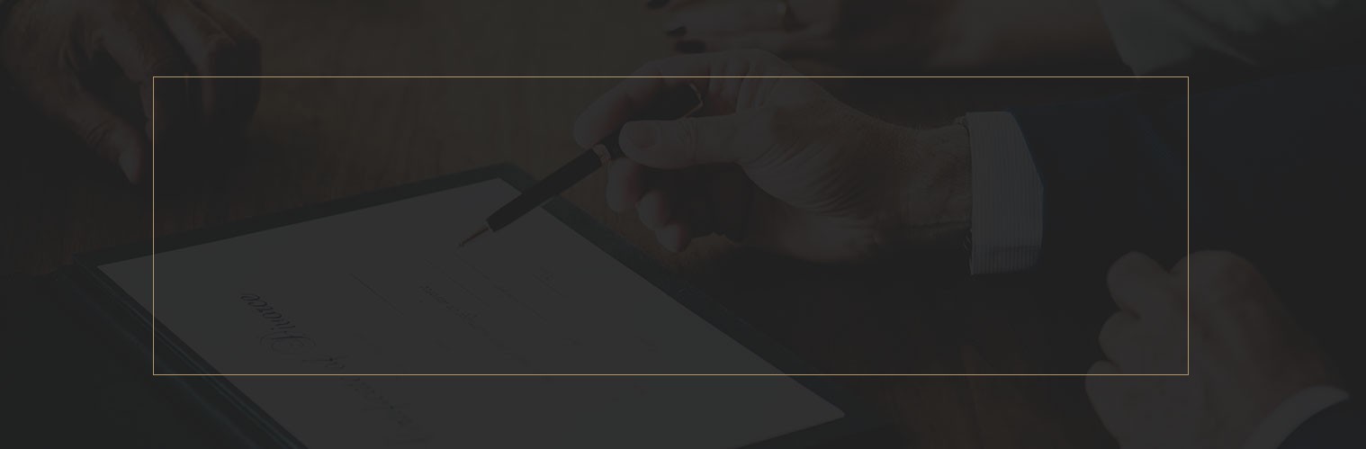 Individual's hand holding a pen above a digital tablet displaying a document.